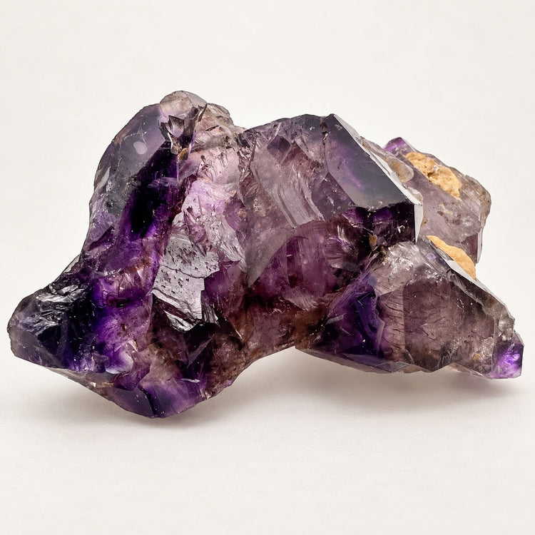 Natural African elestial amethyst cluster with deep-violet color zoning and layered crystal formations