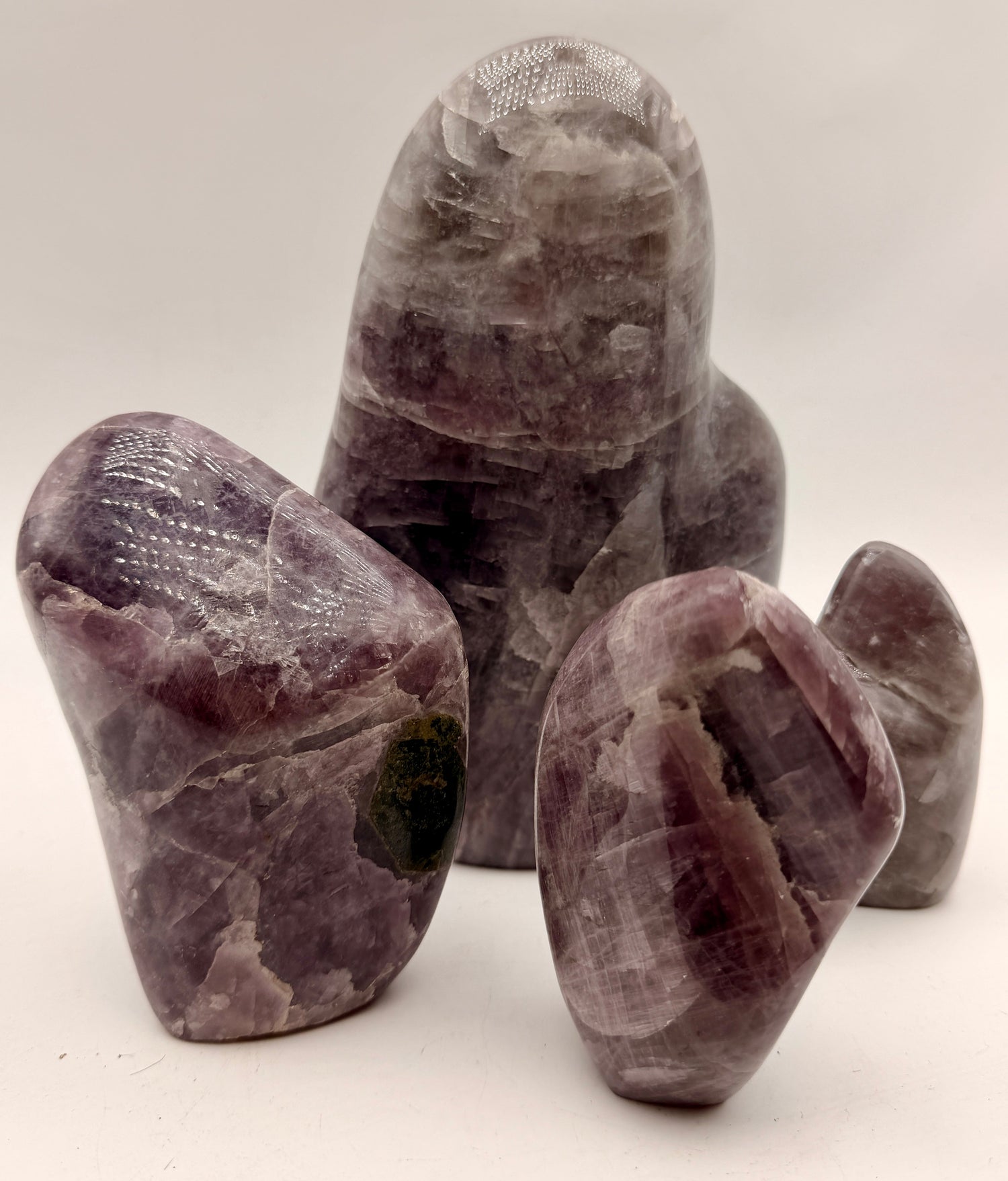 Natural Purple Anhydrite polished free forms featuring soft lavender and cream banding in sculptural display shapes.