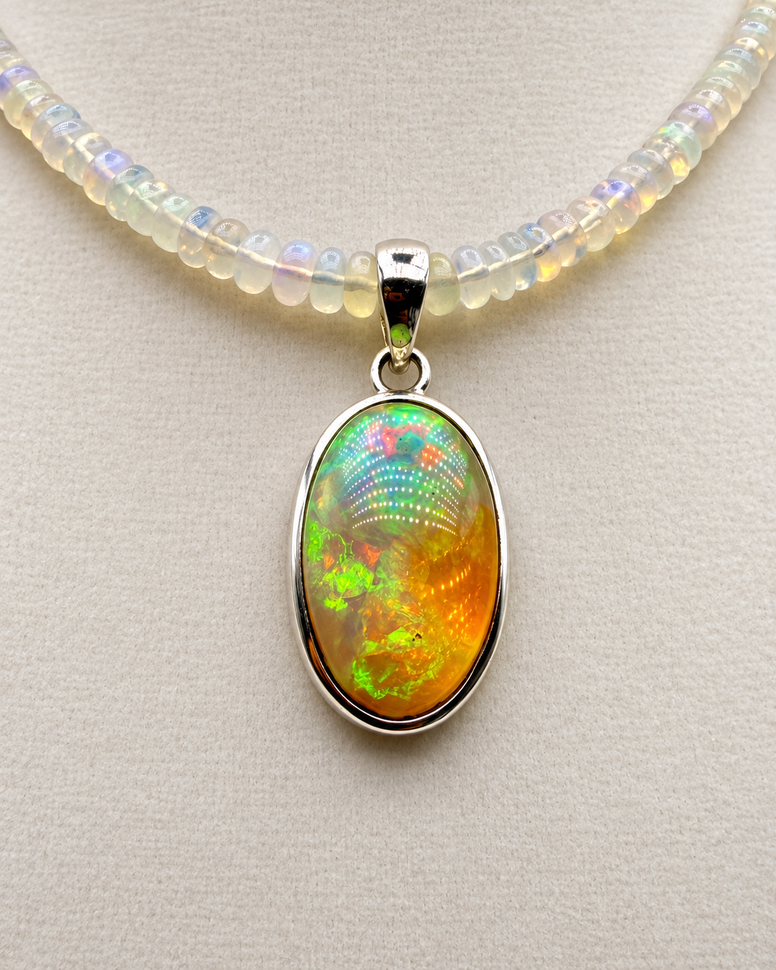 24.04ct Ethiopian opal pendant in sterling silver showing green orange and golden play-of-color