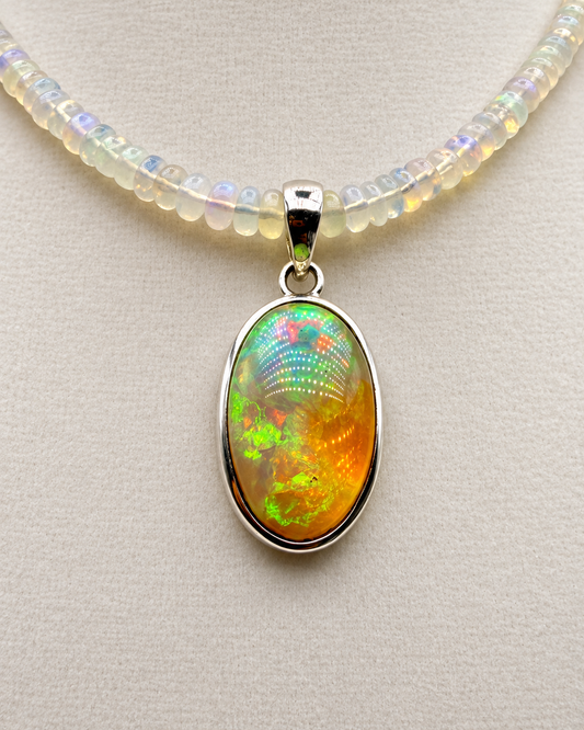 24.04ct Ethiopian opal pendant in sterling silver showing green orange and golden play-of-color