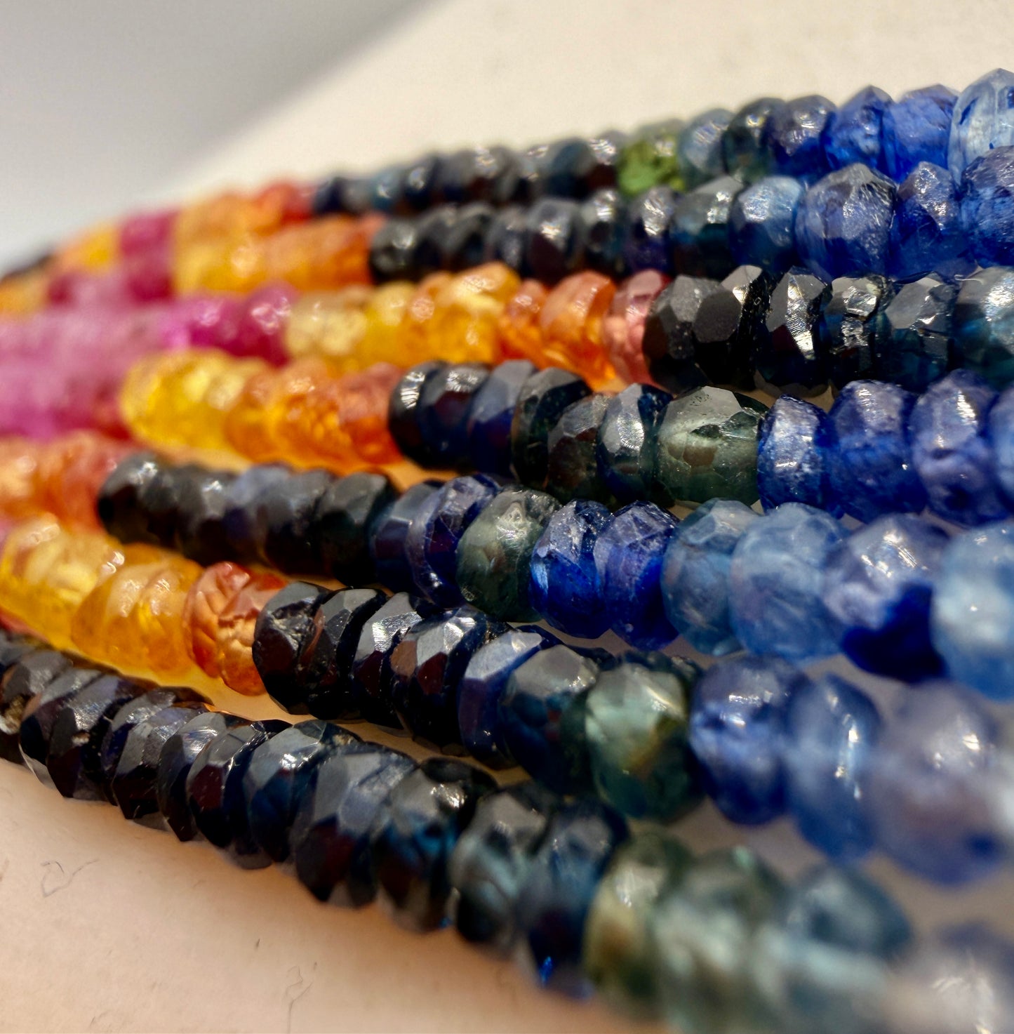 Close-up of deep blue sapphire gemstone strands with faceted beads
