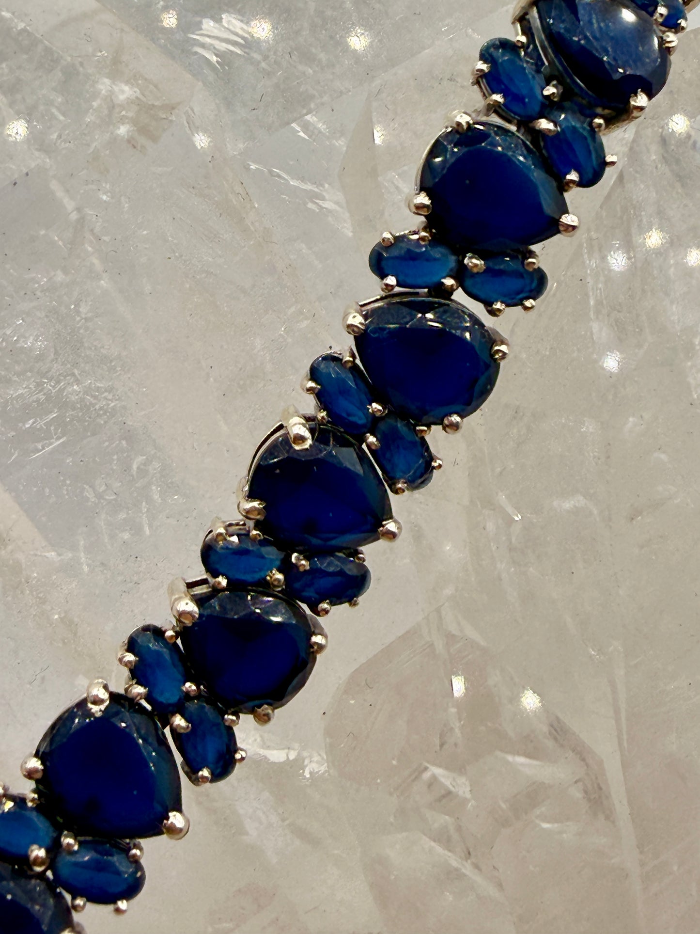 Close-up of deep blue sapphire stones in sterling silver settings
