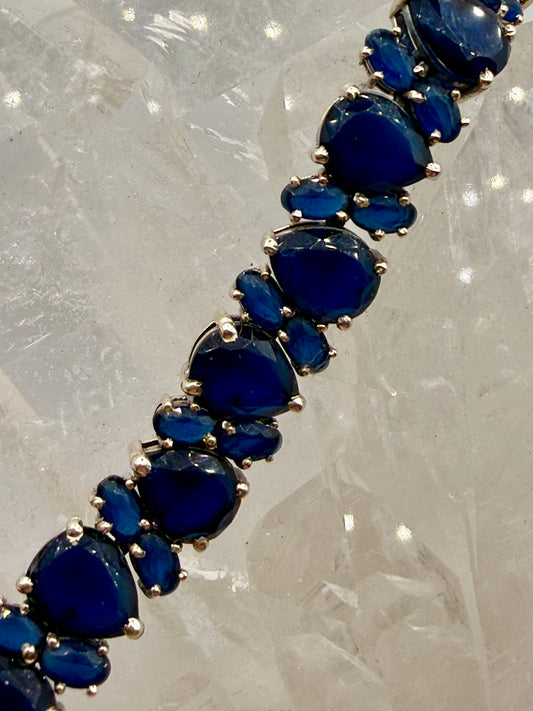 Close-up of deep blue sapphire stones in sterling silver settings