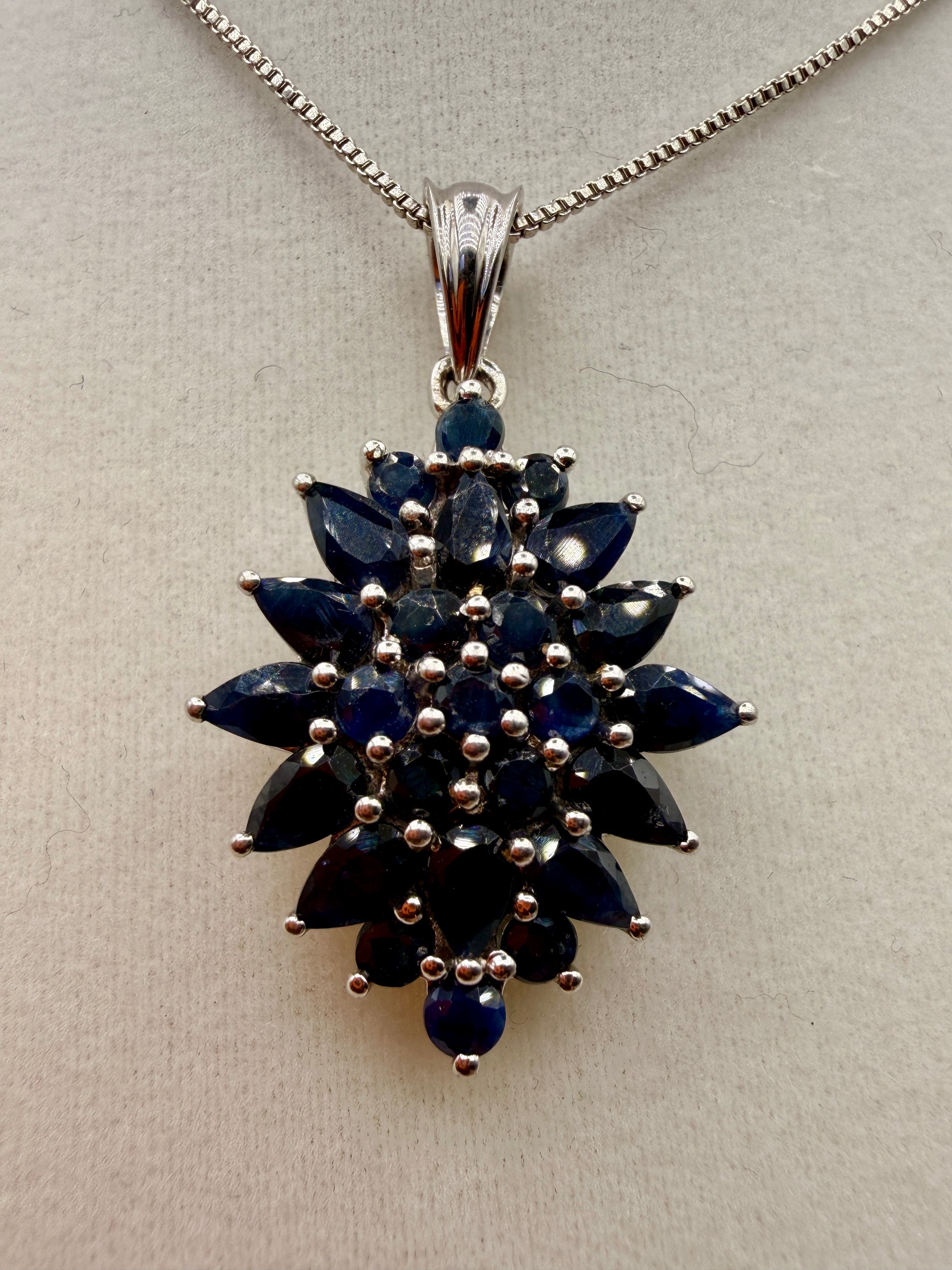 Blue sapphire pendant with marquise pear oval and round gemstones