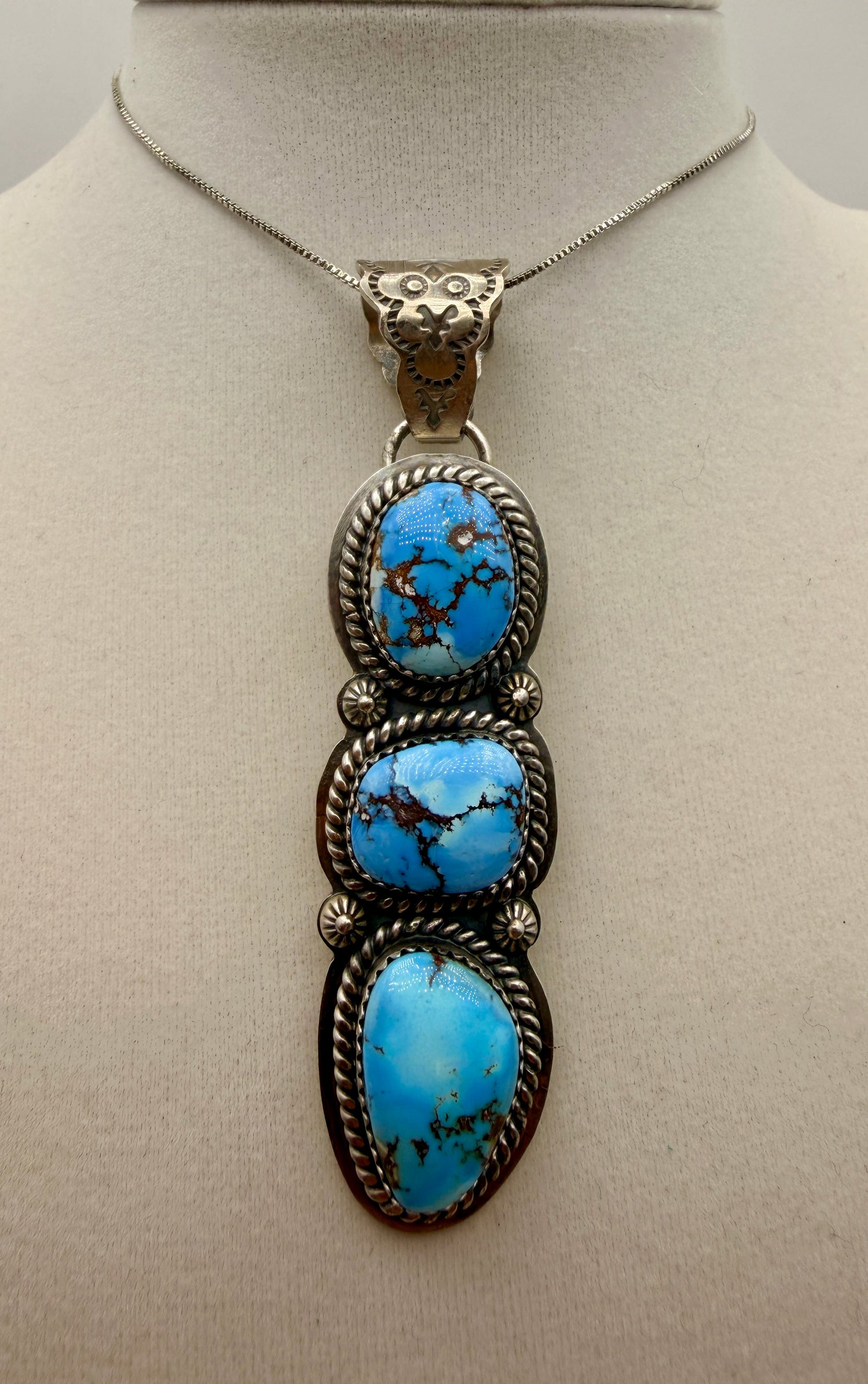 Three-stone Golden Hills turquoise sterling silver pendant with ornate owl-motif bail