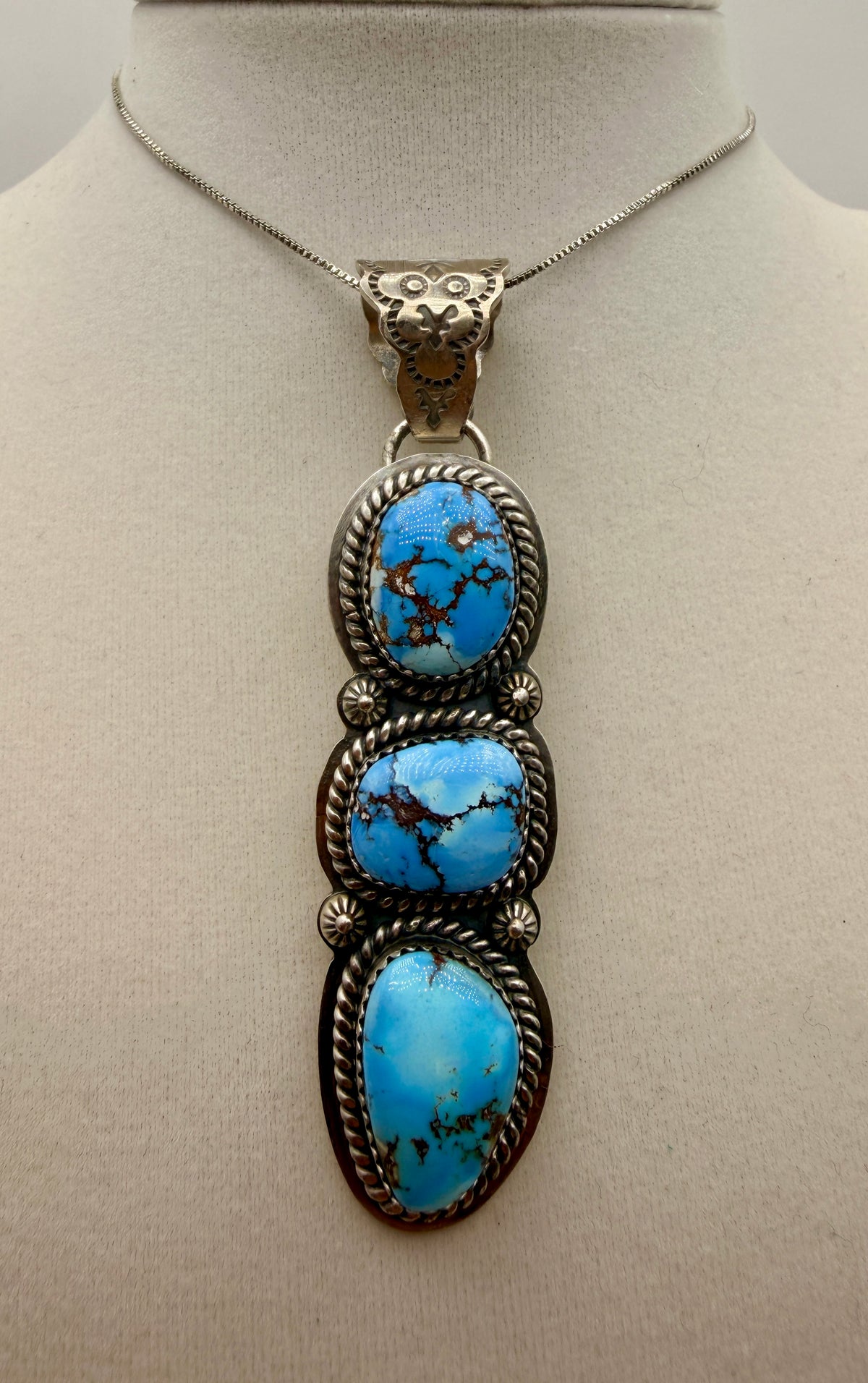 Three-stone Golden Hills turquoise sterling silver pendant with ornate owl-motif bail