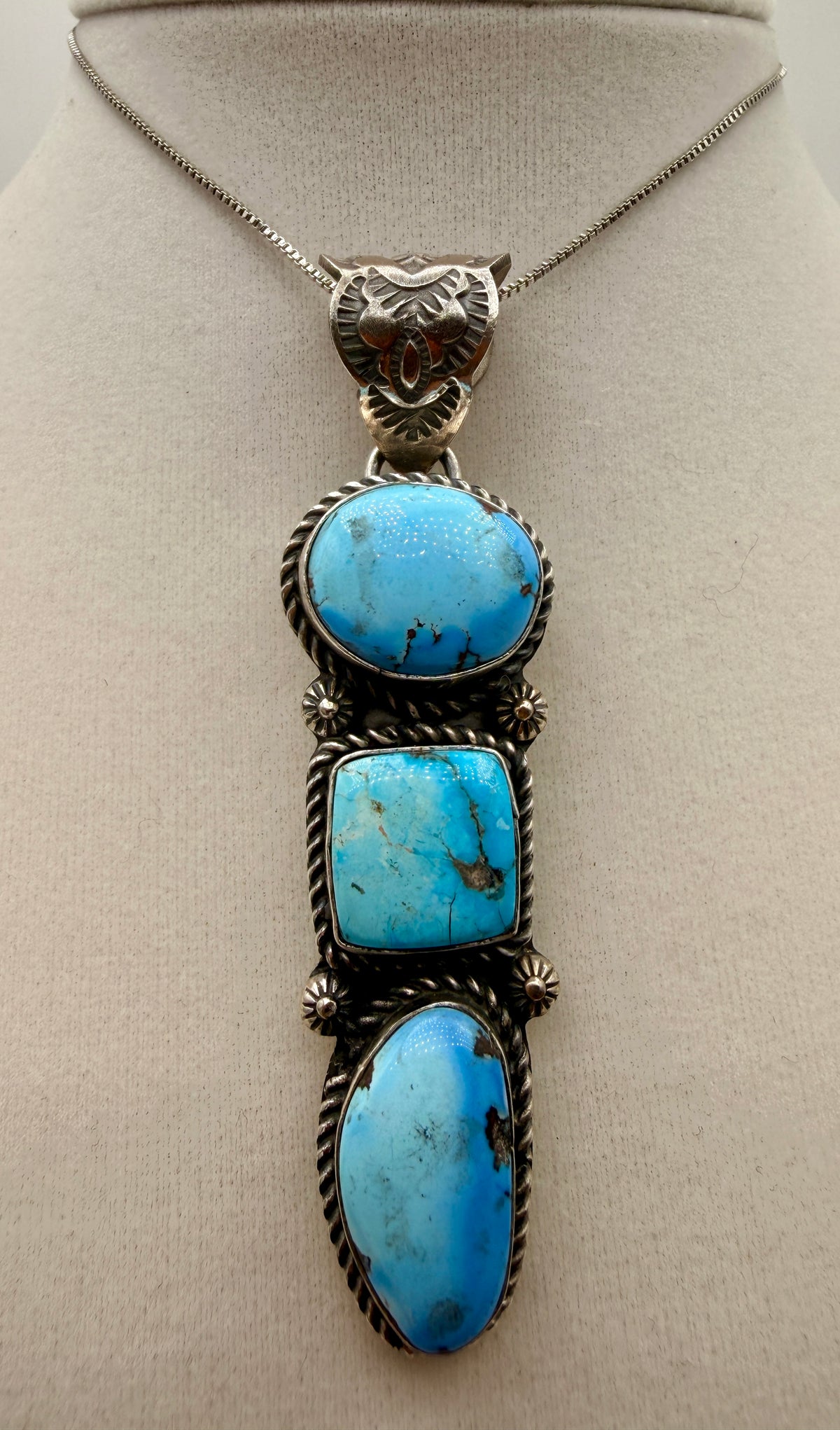 Three-stone Golden Hills turquoise sterling silver drop pendant shown from the front