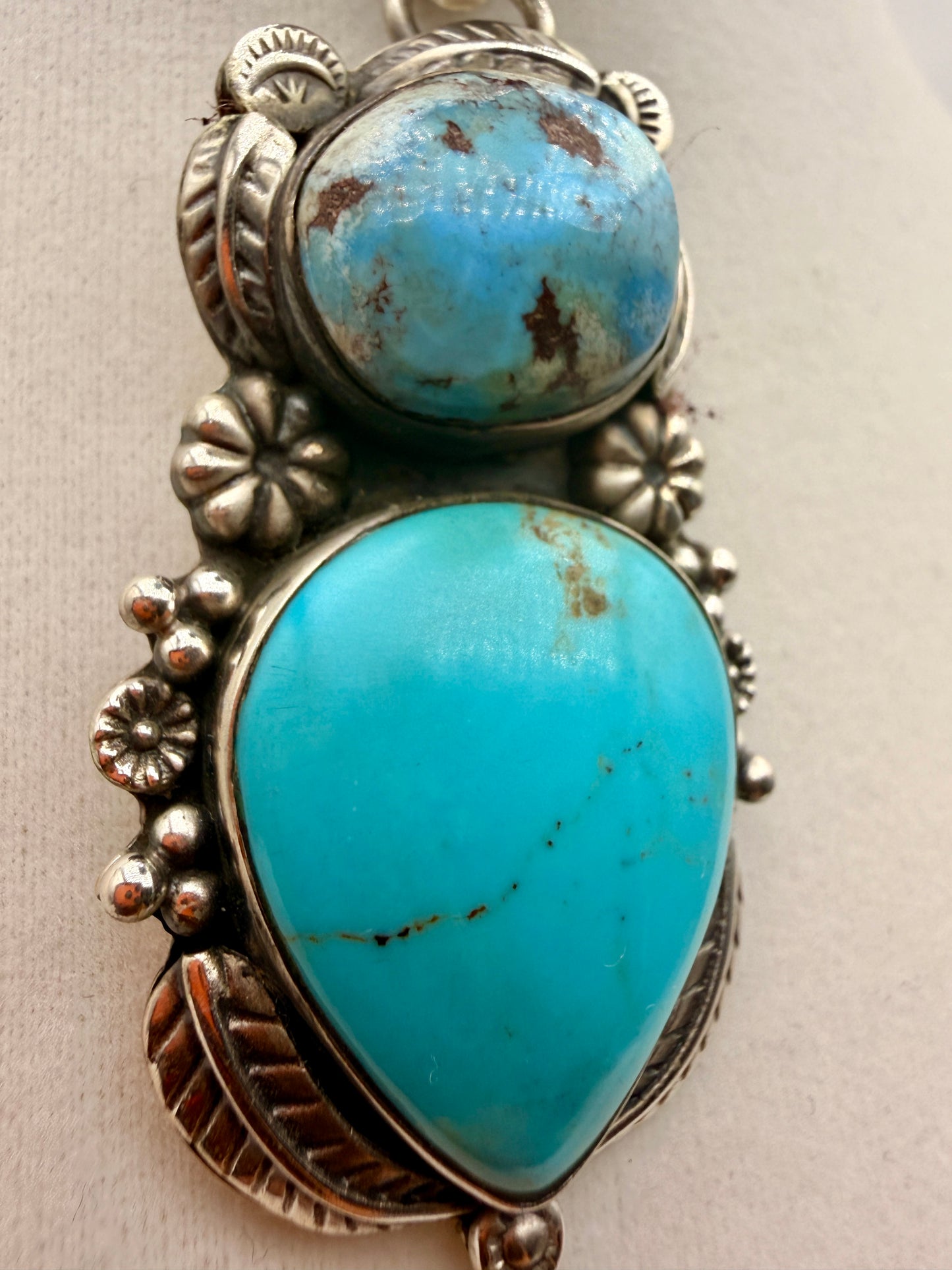 Close-up of Golden Hills and Tyrone turquoise cabochons in sterling silver