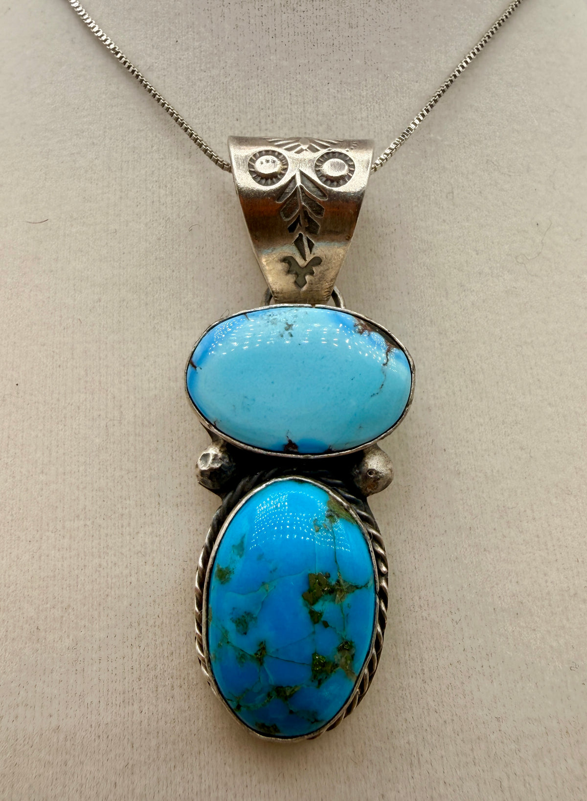 Philbert Nez two-stone Golden Hills turquoise sterling silver pendant shown from the front