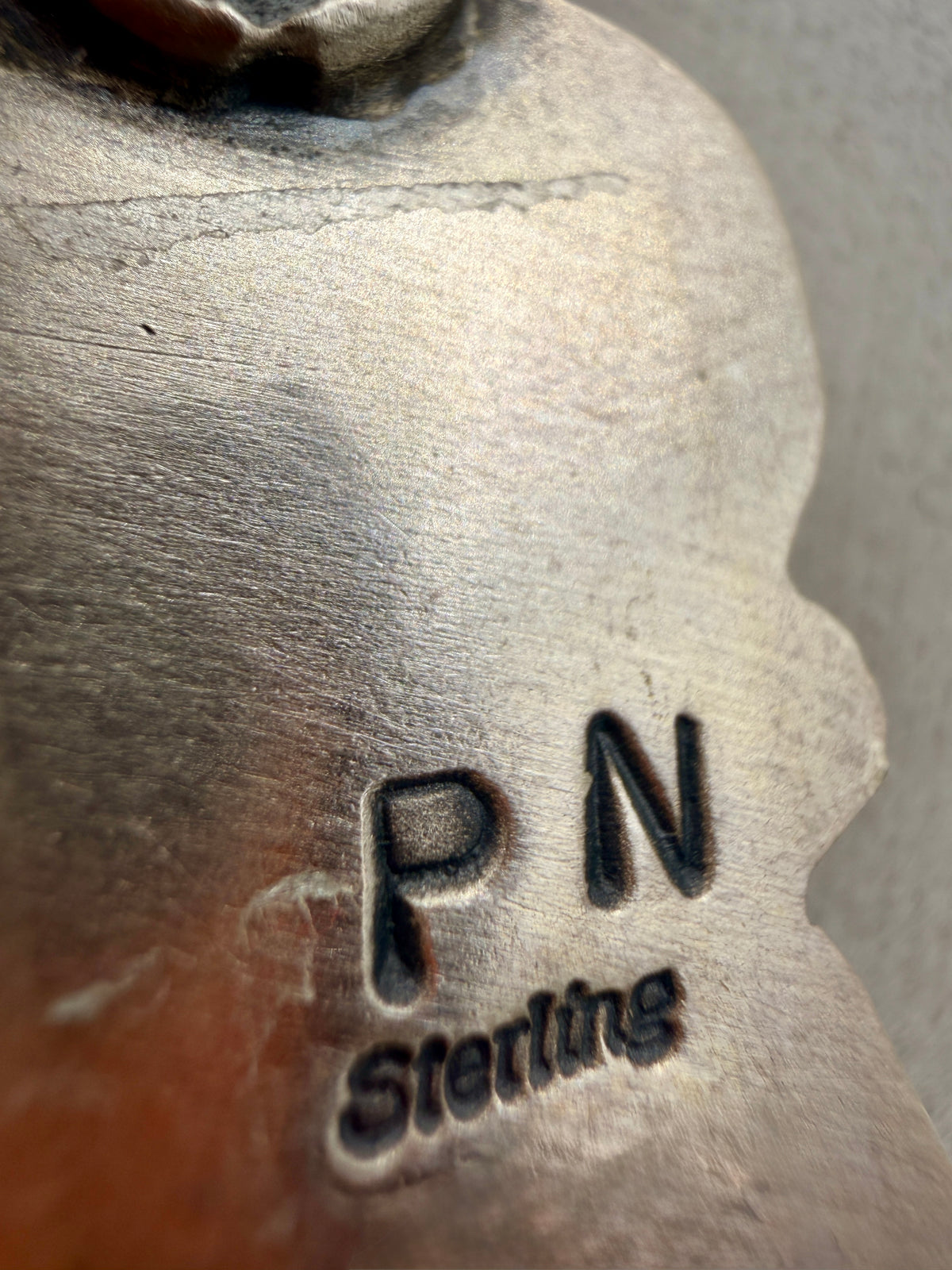 Philbert Nez P N hallmark and Sterling stamp on the back of the pendant