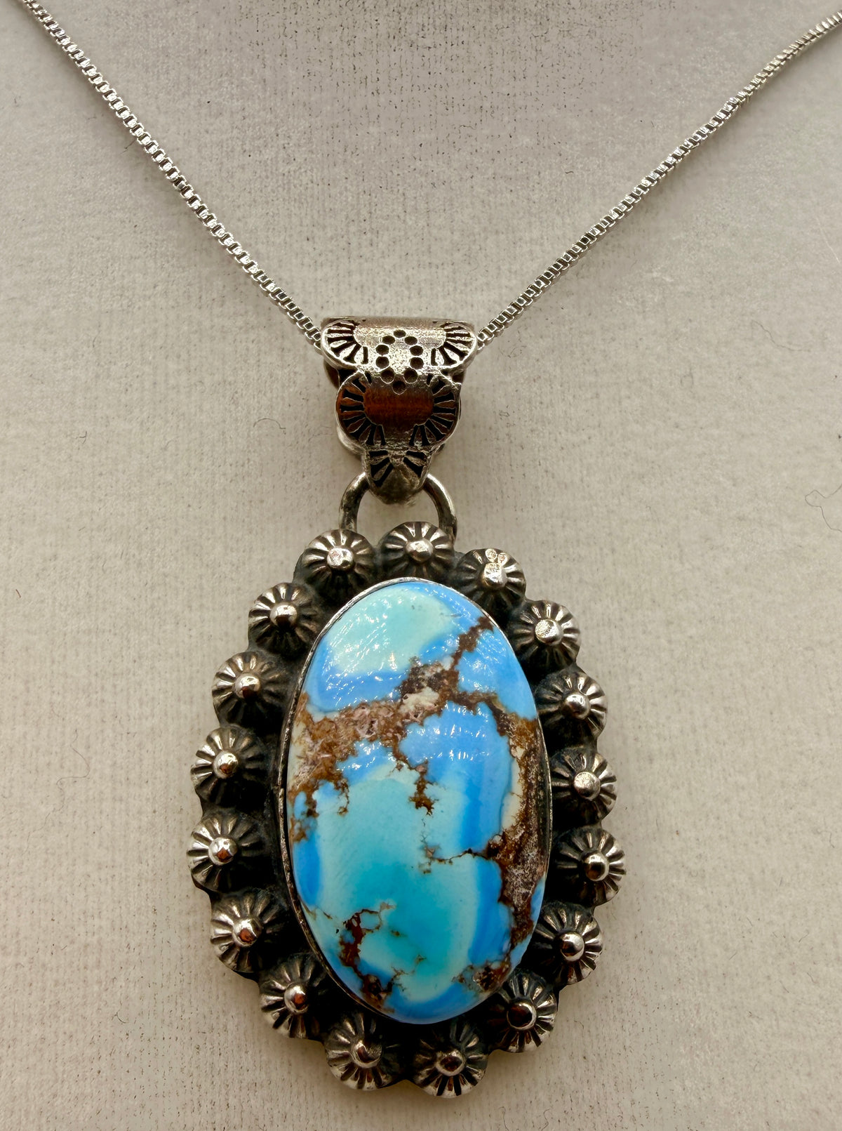 Ned Nez Golden Hills turquoise sterling silver floral pendant shown from the front