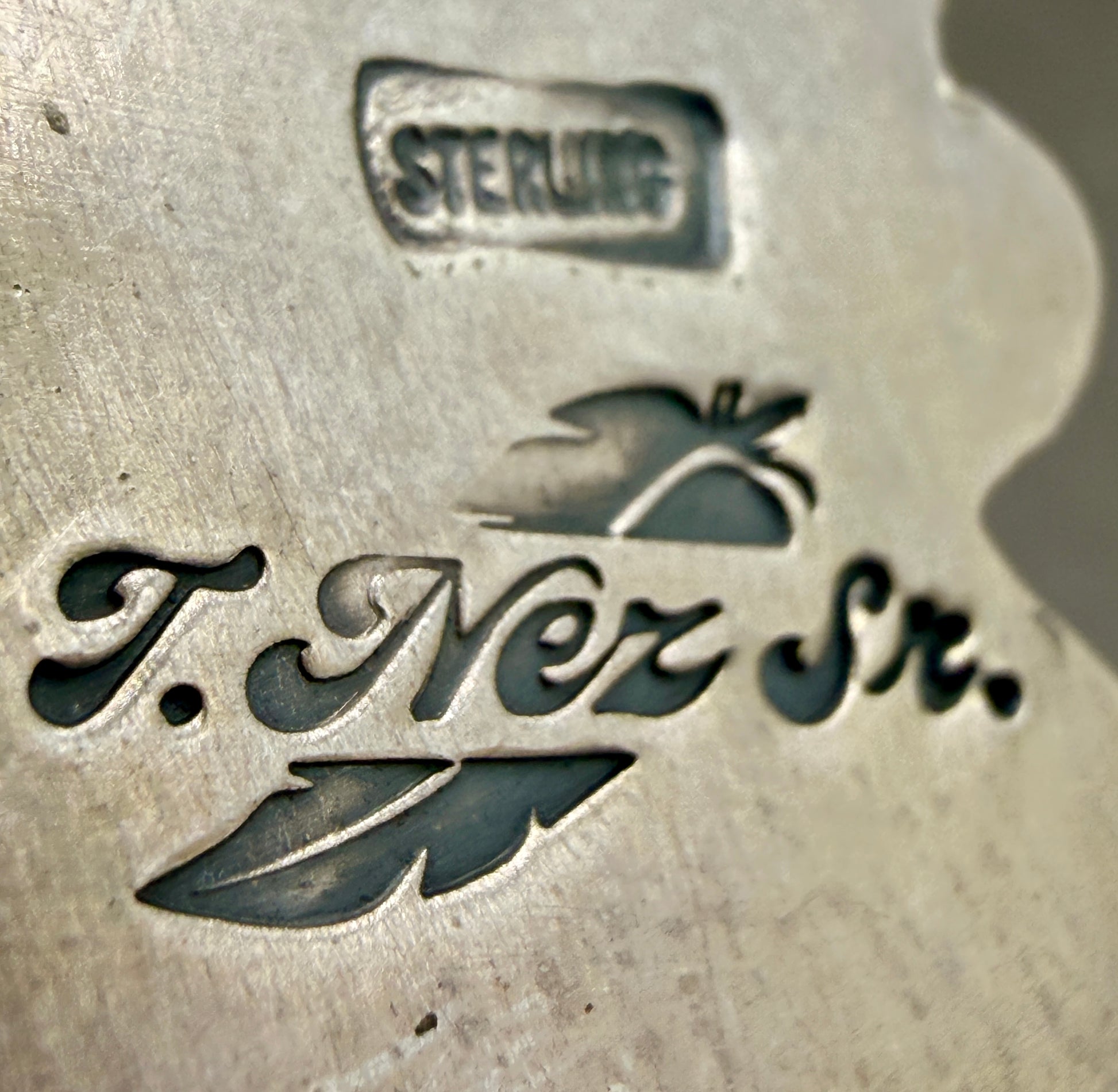T. Nez Sr. artist hallmark and Sterling stamp on the back of the pendant