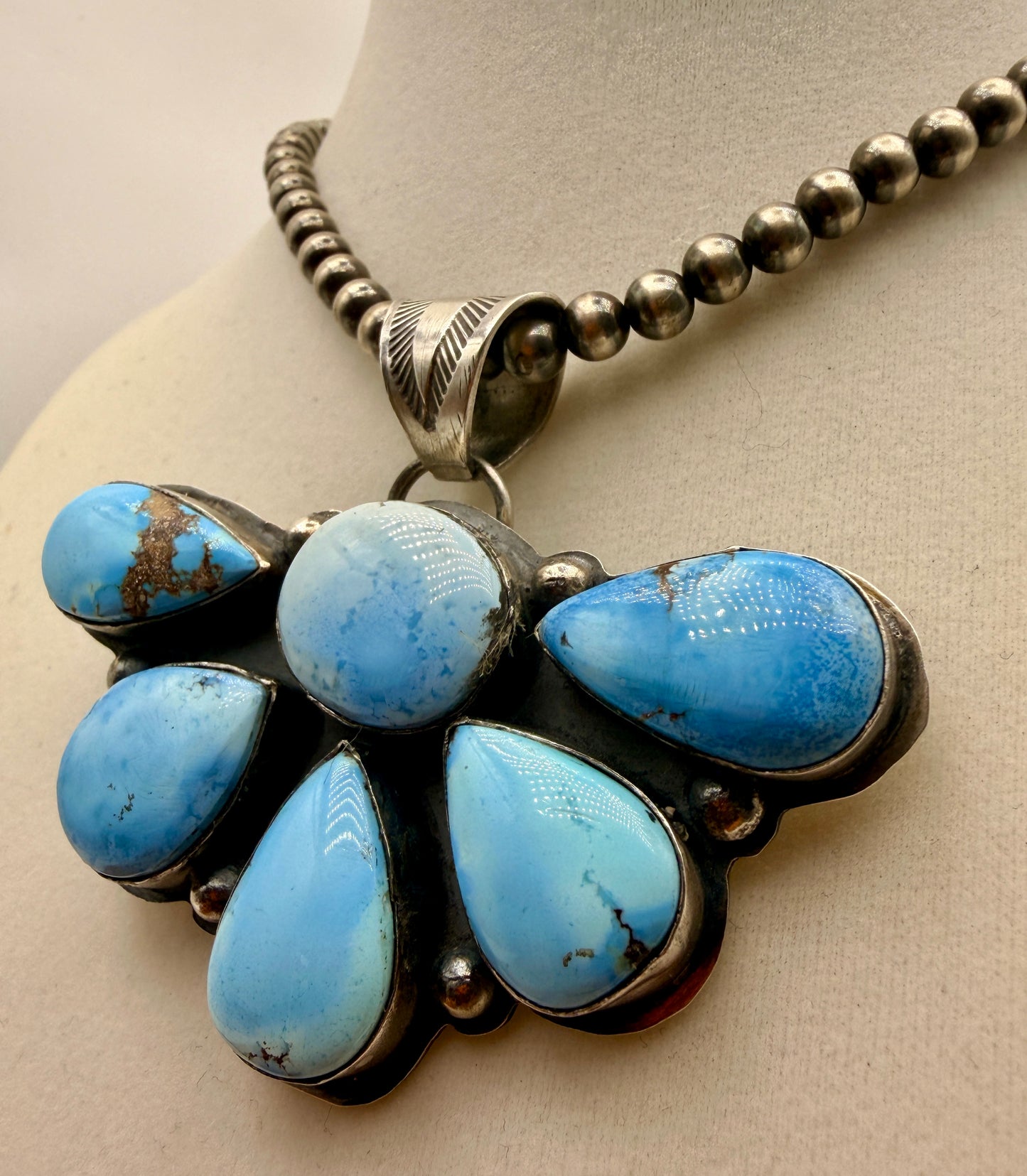 Side view of six Golden Hills turquoise cabochons in sterling silver bezels