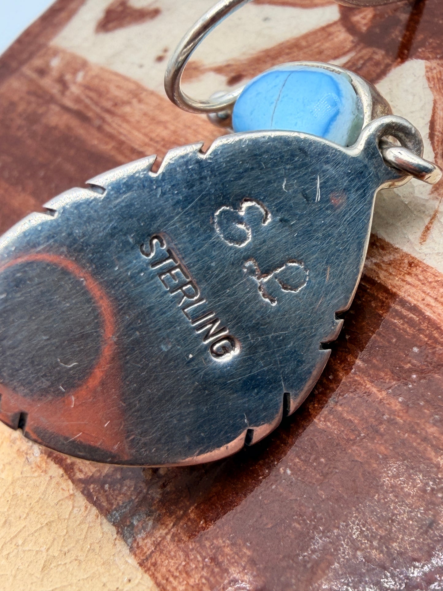 E L artist hallmark and sterling stamp on back of Golden Hills turquoise earring