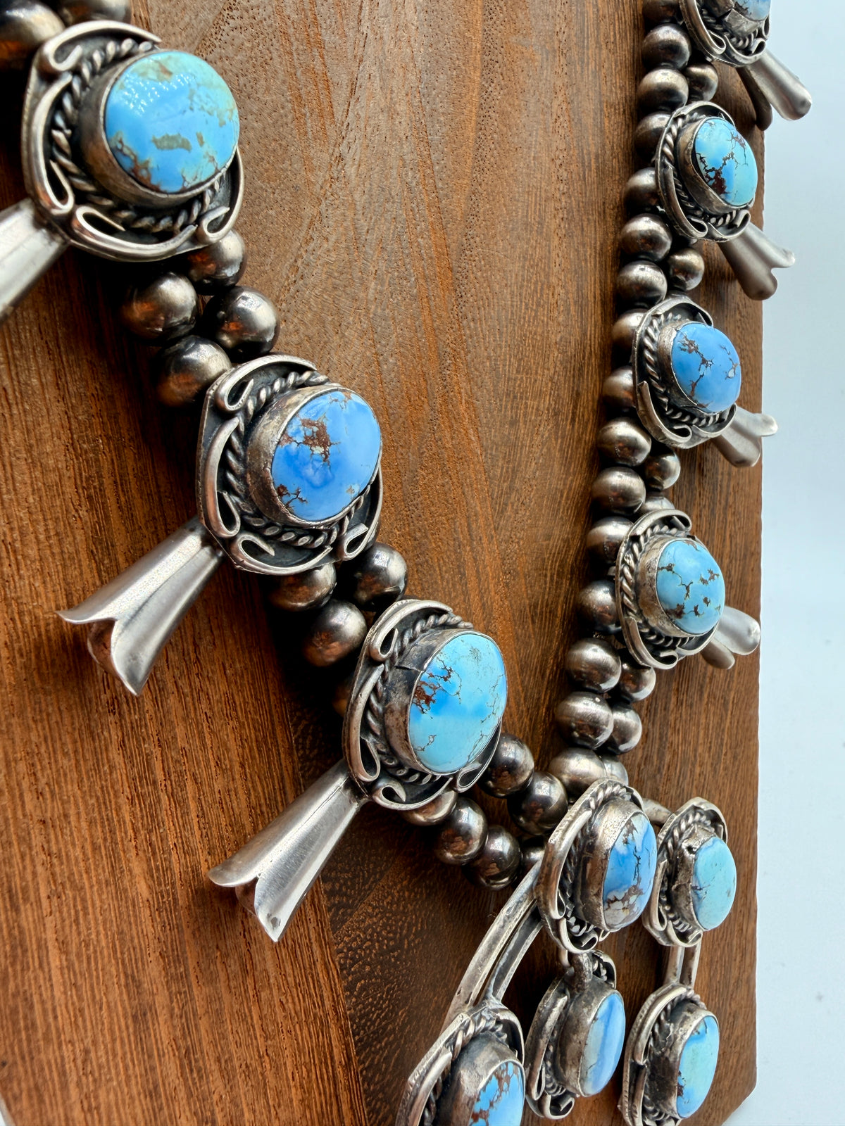 Golden Hills turquoise squash blossom stations on double sterling silver strands