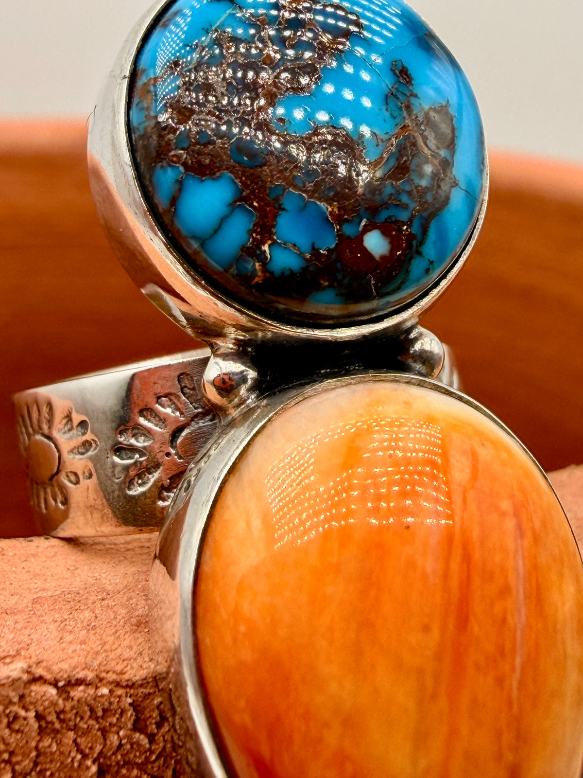 Angled view of Egyptian Turquoise and orange Spiny Oyster sterling silver statement ring