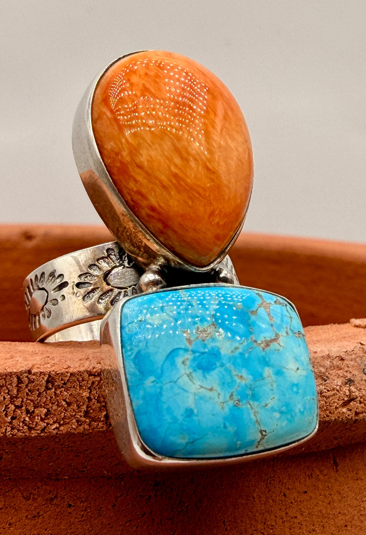 Angled view of Kingman Turquoise and Spiny Oyster adjustable silver ring