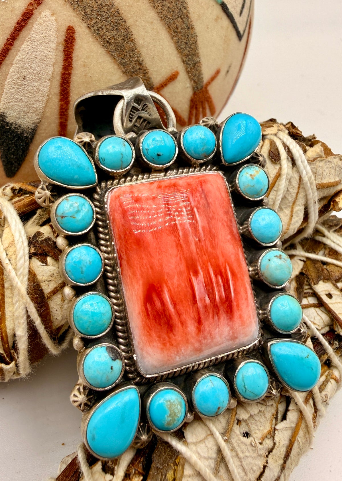 Angled view of Spiny Oyster and Cripple Creek Turquoise pendant