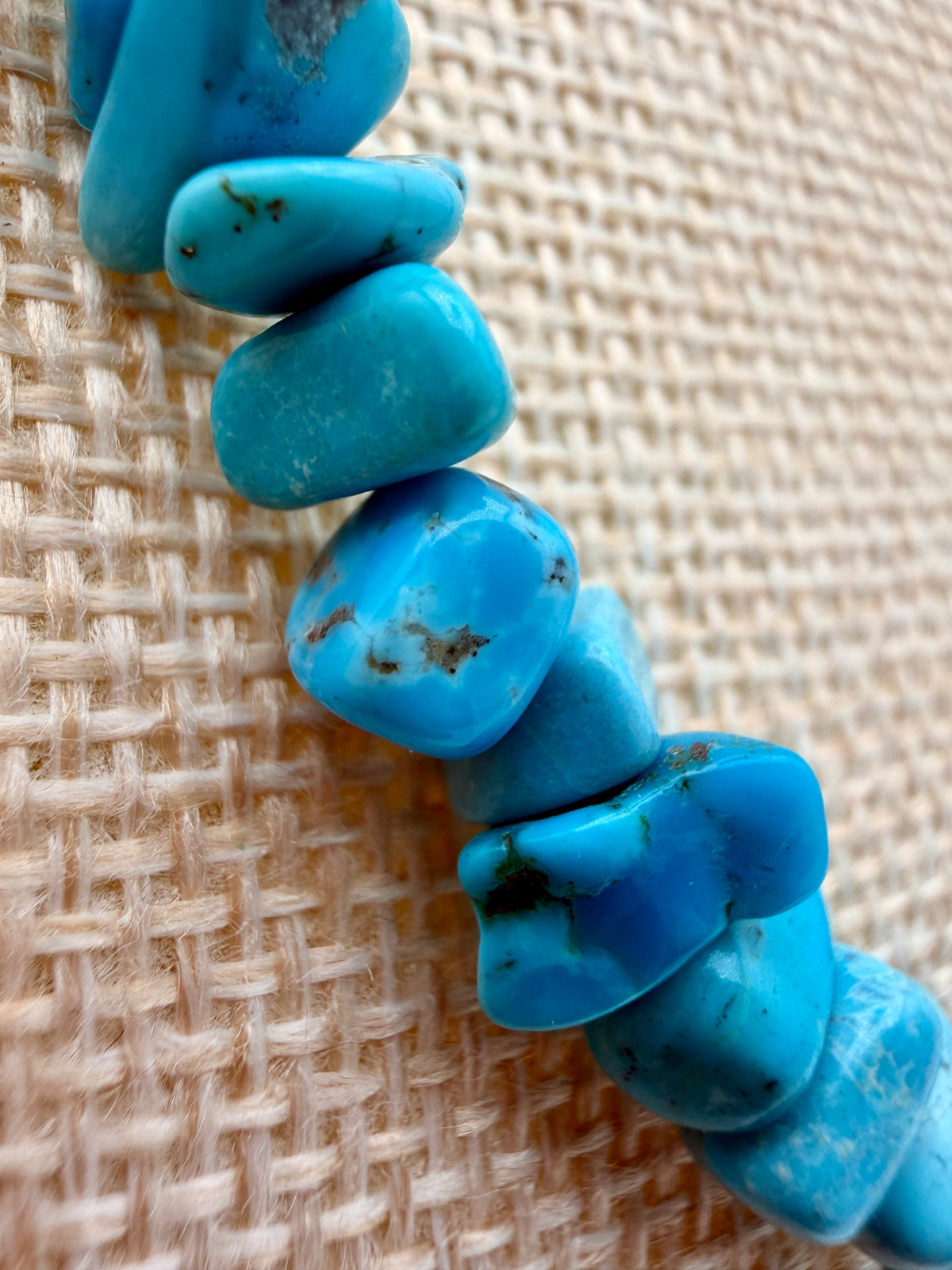 lose-up of natural Sleeping Beauty Turquoise nugget beads showing blue color and natural matrix