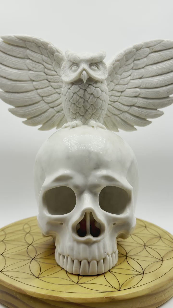 360-degree view of Messenger of Death white jade skull and owl carving showing detailed wings, skull profile and natural gray stone veining