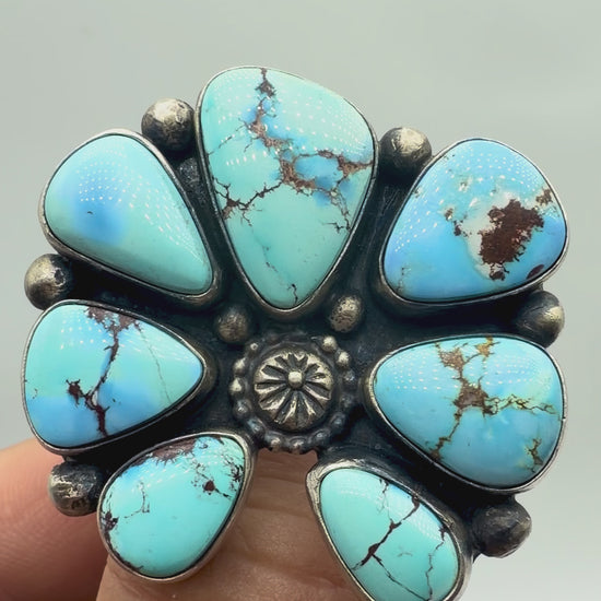 Video showing the Golden Hills turquoise stones, sterling silver cluster setting and adjustable band of a Travis Jim ring