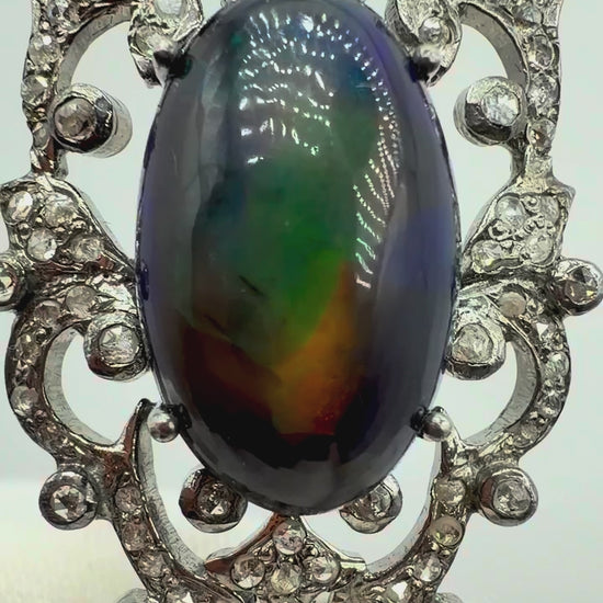 6.75 carat Australian black opal and diamond sterling silver pendant showing vivid shifting blue green red and orange play-of-color