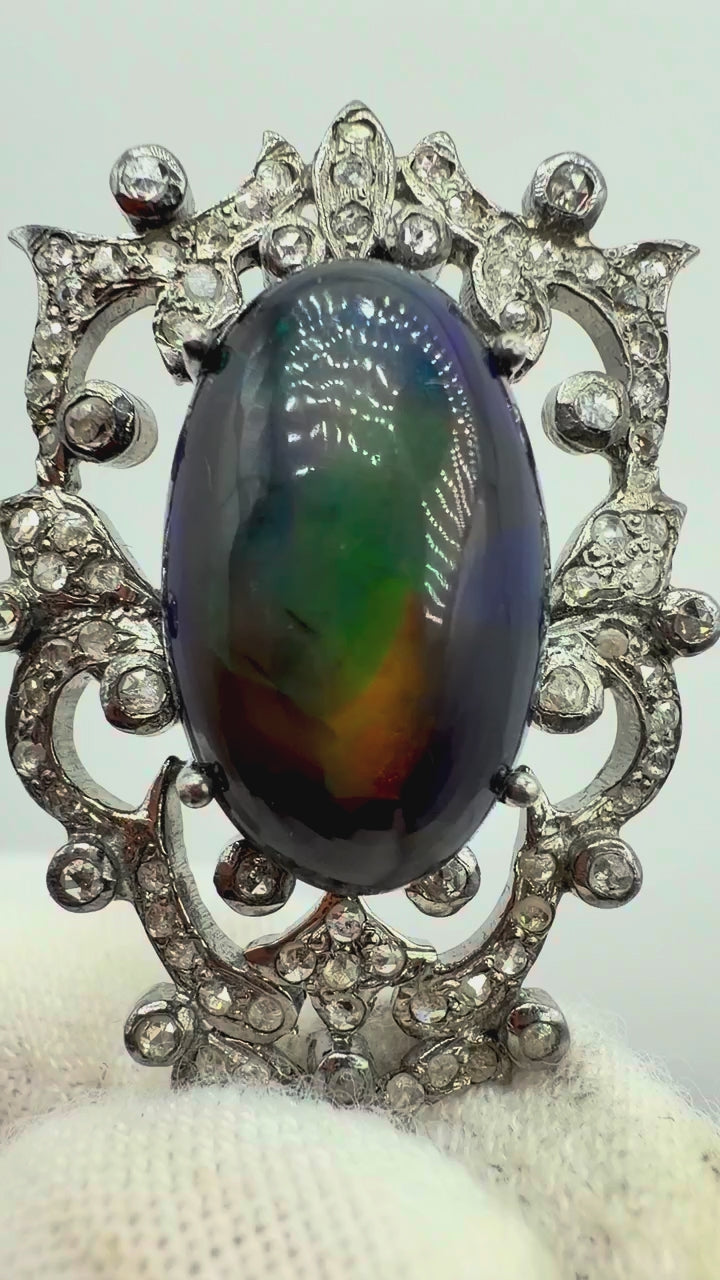 6.75 carat Australian black opal and diamond sterling silver pendant showing vivid shifting blue green red and orange play-of-color