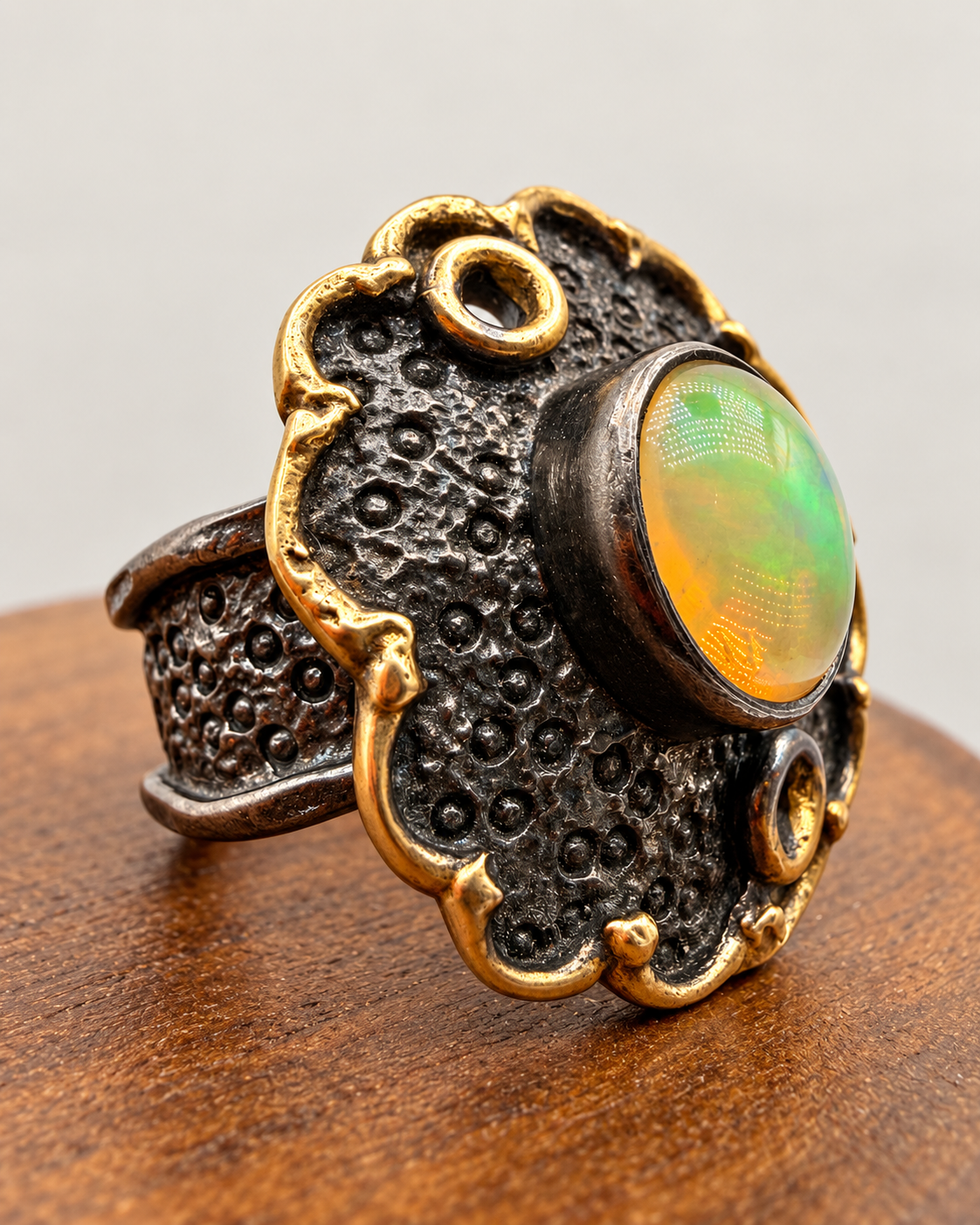 Angled view of rhodium plated silver opal ring with gold plated accents